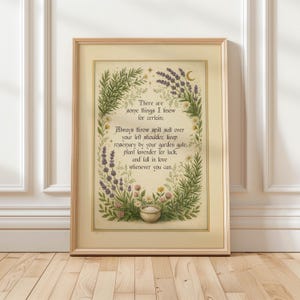 May include: A framed wall art print featuring a cream-colored background with a botanical border of green rosemary, purple lavender, and small flowers. The text reads: There are some things I know for certain: Always throw spill salt over your left shoulder.