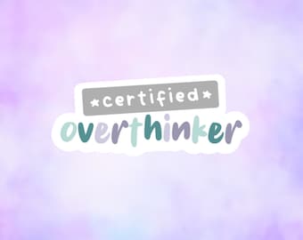 May include: A sticker with a white background and a gray rectangle with the text "*certified*" and the text "overthinker" in teal and purple letters.