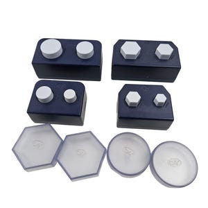 May include: A set of three ceramic vases in varying heights and shapes. The vases are glazed in a matte white finish, offering a minimalist aesthetic. The tallest vase is approximately 10 inches high.