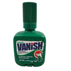 May include: Green plastic bottle of Vanish Automatic Toilet Cleaner with a push-top dispenser. The label says "Continuous Cleaning... Deodorizes Too!" and "12 FL. OZ".