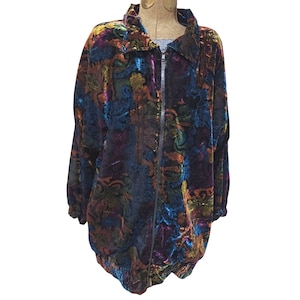 May include: A long-sleeve zip-up jacket made of velvet fabric featuring a multi-colored abstract pattern in shades of blue, purple, gold, and orange. The jacket includes a standard collar, a full-length front zipper, and elasticized cuffs and hem.