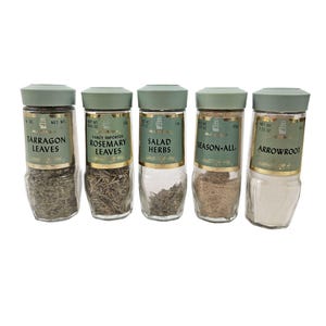 May include: Five glass spice jars with green lids and labels. The labels read: Tarragon Leaves, Rosemary Leaves, Salad Herbs, Season-All, and Arrowroot. The jars are filled with various herbs and spices.