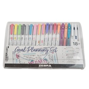 May include: A clear plastic package containing a Zebra Goal Planning Set. The set includes 18 pens and highlighters in various colors, with the text "Goal Planning Set" and "Wellness" visible on the packaging.