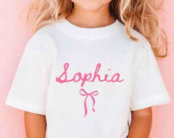 Camiseta con nombre personalizado para niña, camiseta con nombre para niña pequeña, camiseta con lazo coqueto, camiseta con nombre personalizado, regalo de cumpleaños para niña pequeña, camiseta con lazo preppy para niños