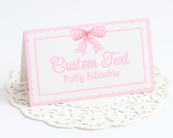 May include: Pink and white place card with a pink gingham bow and the text "Custom Text Fully Editable".