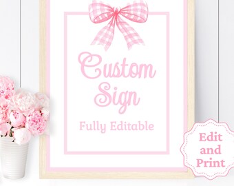 Peut inclure: Une affiche imprimable avec un nœud en vichy rose et le texte "Custom Sign Fully Editable" en rose. Un cercle rose avec le texte "Edit and Print" se trouve dans le coin inférieur droit.