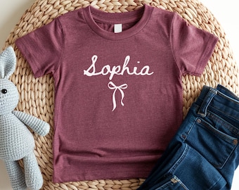 Camiseta con nombre personalizado para niña, camiseta con nombre para niña pequeña, camiseta con lazo coqueto, camiseta con nombre personalizado, regalo de cumpleaños para niña pequeña, camiseta con lazo preppy para niños