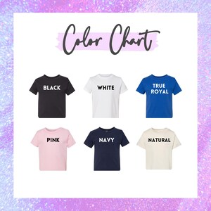 May include: A color chart displaying six short-sleeved t-shirts in various colors: black, white, true royal, pink, navy, and natural. Each shirt has its color name printed in a bold, sans-serif font.