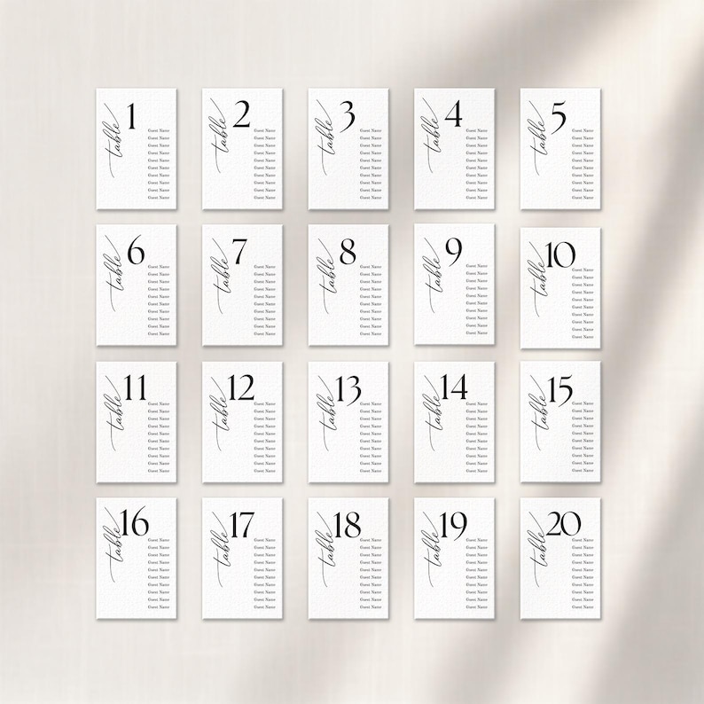 May include: Twenty white table number cards with black calligraphy font. Each card has a number from 1 to 20, the word "table", and space for guest names. Ideal for weddings, parties, and events.