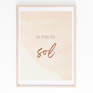 May include: A framed print with a watercolor background in shades of peach and cream. The text "tu eres mi sol" is written in brown cursive script.