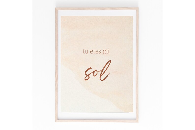 May include: A framed print with a watercolor background in shades of peach and cream. The text "tu eres mi sol" is written in brown cursive script.