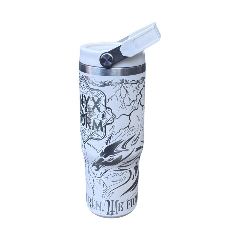 May include: White insulated drinks tumbler featuring a black and white dragon design and the text "NYX STORM". The tumbler has a white handle and lid. The design includes lightning bolts and the words "RUN. WE FIGHT."