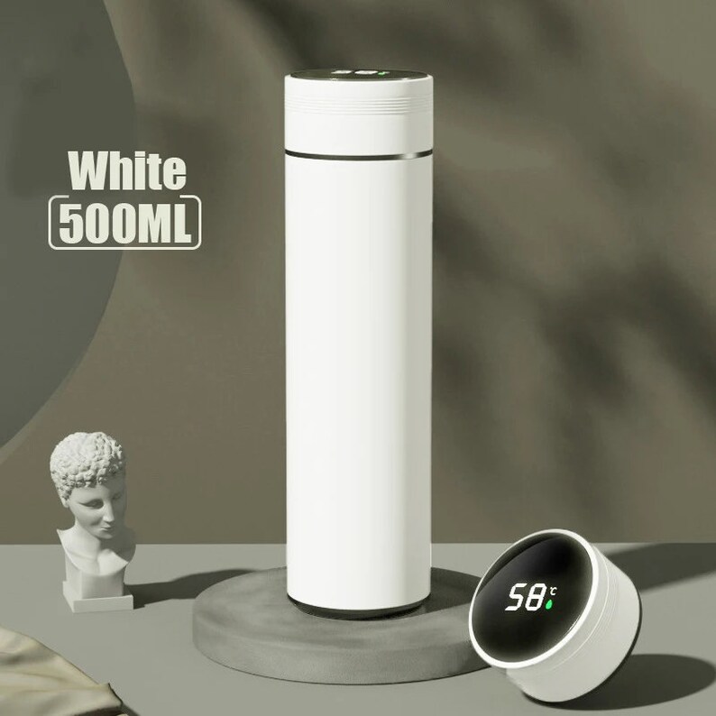 A white cylindrical thermos with a digital temperature display showing 33°C on its lid, placed on a white surface.