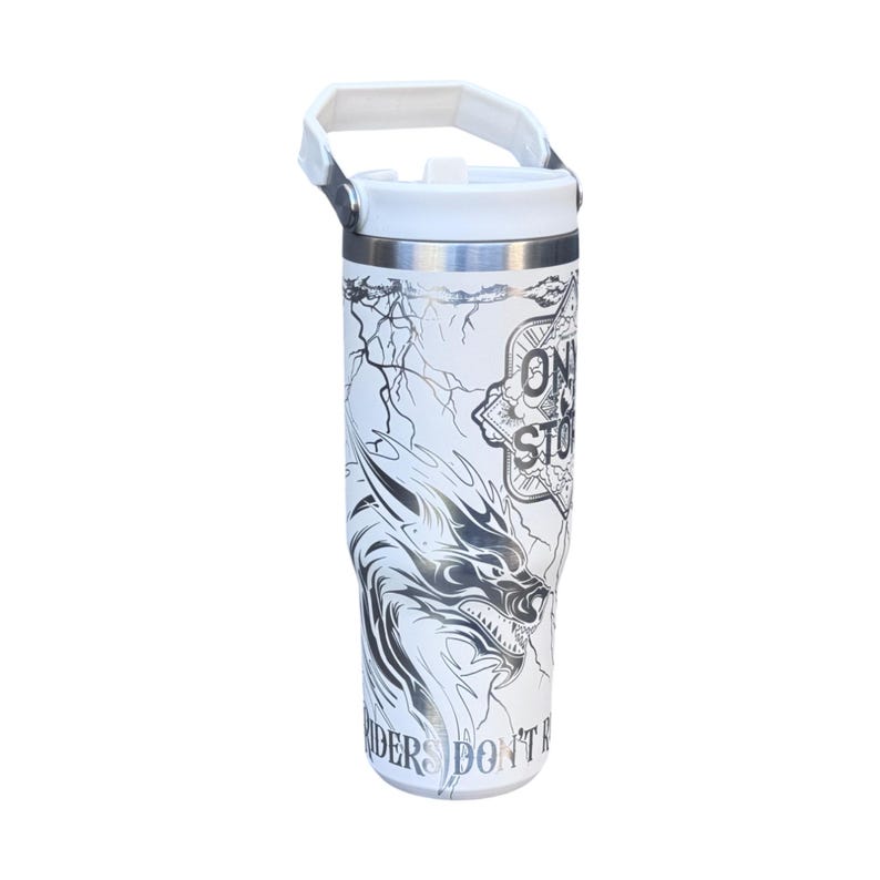 May include: White insulated tumbler with a black and silver dragon graphic. The tumbler has a white lid and handle. The text "ONE STOP" and "RIDERS DON'T" are also visible on the tumbler.