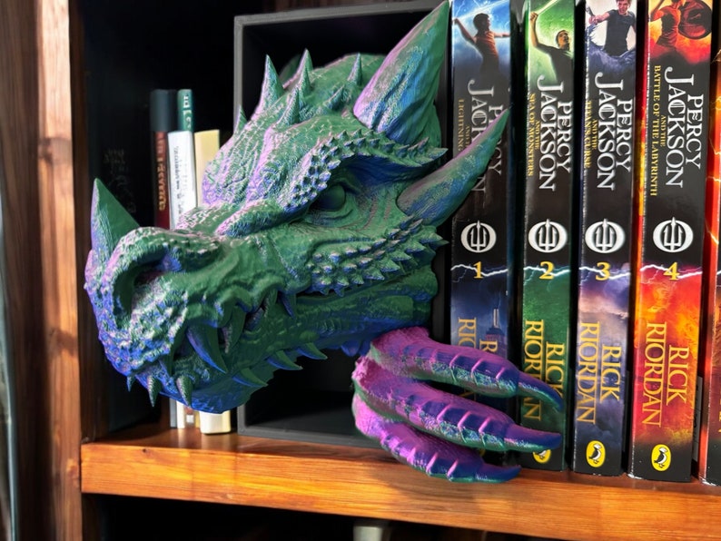 A dragon-themed bookend elegantly displaying a stack of books, merging artistic flair with a love for reading.