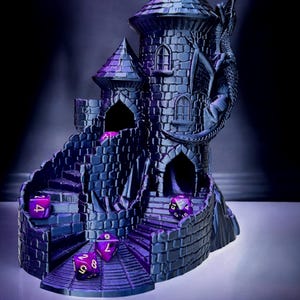 May include: A purple and black 3D printed dragon tower dice rolling game. The tower has a dragon wrapped around it and a spiral staircase leading to the top. There are five purple dice in the tower.
