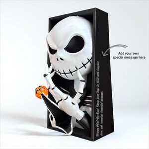 May include: A black and white Jack Skellington figurine holding a small orange pumpkin. The figurine is in a black frame with the text "Happy 60th Birthday! May your days be filled with laughter, love, and countless beautiful moments."