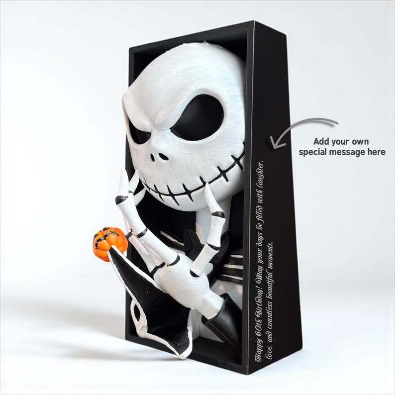 May include: A black and white Jack Skellington figurine holding a small orange pumpkin. The figurine is in a black frame with the text "Happy 60th Birthday! May your days be filled with laughter, love, and countless beautiful moments."