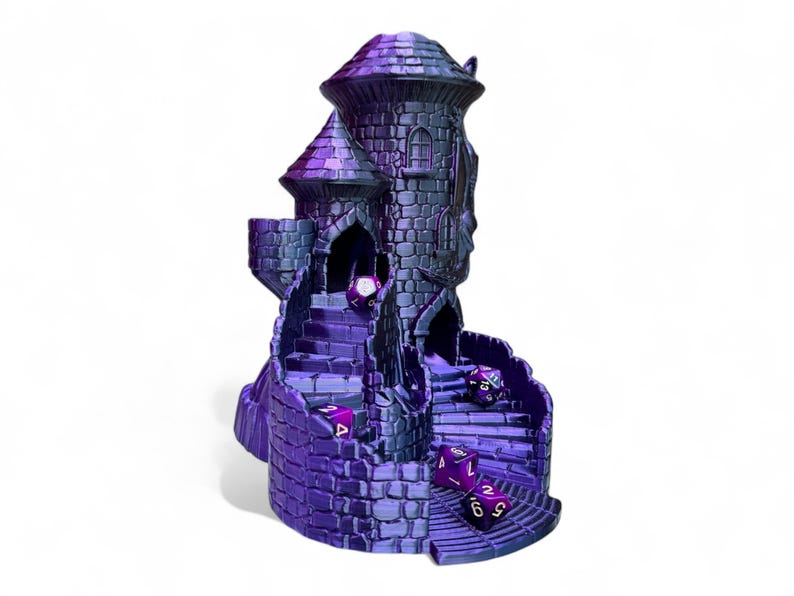 May include: A purple and blue 3D printed castle-shaped dice tower with a winding staircase and multiple dice rolling down the steps.