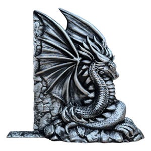May include: A silver dragon bookend with wings spread wide and a textured stone base. The dragon is curled up with its head resting on its tail.