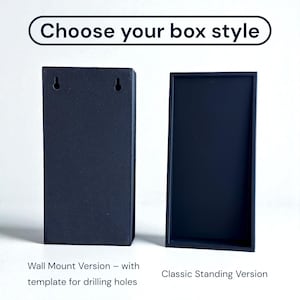 May include: Two black rectangular boxes are displayed against a white background. The text "Choose your box style" is at the top. One box is labeled "Wall Mount Version" and the other is labeled "Classic Standing Version".