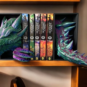 A dragon-themed bookend elegantly displaying a stack of books, merging artistic flair with a love for reading.