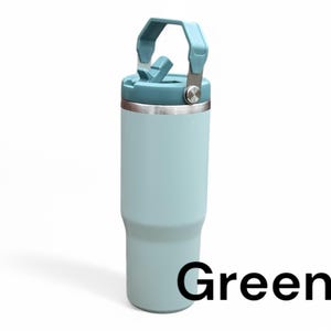 May include: A light blue stainless steel travel mug with a carrying handle and a lid. The mug has a green label that says "Green".