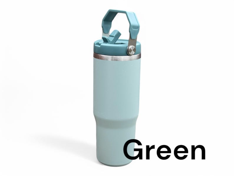 May include: A light blue stainless steel travel mug with a carrying handle and a lid. The mug has a green label that says "Green".