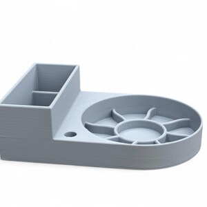 May include: A light gray desktop organizer with a compartment for pens and pencils, a circular tray with multiple compartments, and a small hole for a cable.