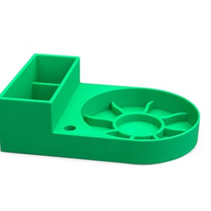 May include: A bright green plastic organizer with a divided compartment and a circular dish with multiple sections. The organizer is designed for holding small items.