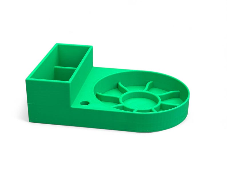 May include: A bright green plastic organizer with a divided compartment and a circular dish with multiple sections. The organizer is designed for holding small items.