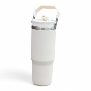 May include: A white insulated travel mug with a handle and a straw lid. The mug has a stainless steel band around the middle.