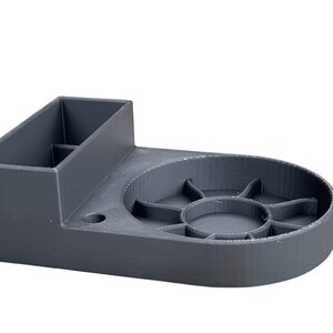 May include: A gray 3D printed organizer with a compartment for storing items and a circular tray with multiple sections.