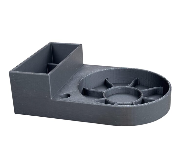 May include: A gray 3D printed organizer with a compartment for storing items and a circular tray with multiple sections.