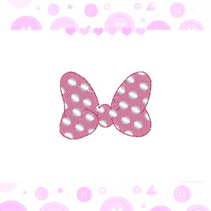 May include: A pink bow with a white polka dot pattern and a subtle ribbed texture. The bow features a central knot and two symmetrical loops, presented against a white background decorated with a border of pink buttons and small hearts.
