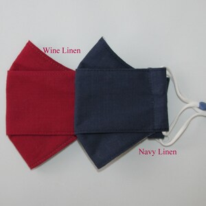May include: Two face masks, one wine linen and one navy linen, with white ties and blue toggles.