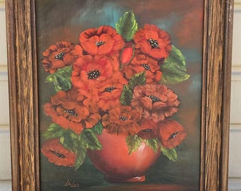Vintage oil painting featuring a bouquet of red poppies in a rustic wood frame, signed "Delois"
