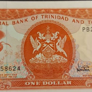 May include: A one dollar bill from the Central Bank of Trinidad and Tobago. The bill features a red and orange color scheme with a coat of arms and a bird in the center. The bill also has the text "PB258624" printed on it.