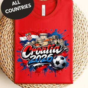 A red t-shirt with a graphic design featuring the text "Croatia 2020" and a soccer ball, along with a flag and splatter-like elements.