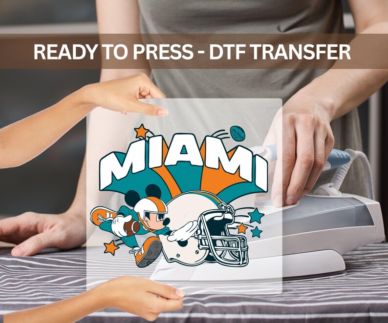 The image is a collage of two people interacting with a Miami Dolphins football helmet, with one person holding the helmet up to the other person's face.