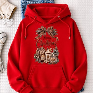 A red hoodie with a Christmas-themed design, including a bow, pine cones, and a mug with a Christmas tree, is displayed on a white surface.