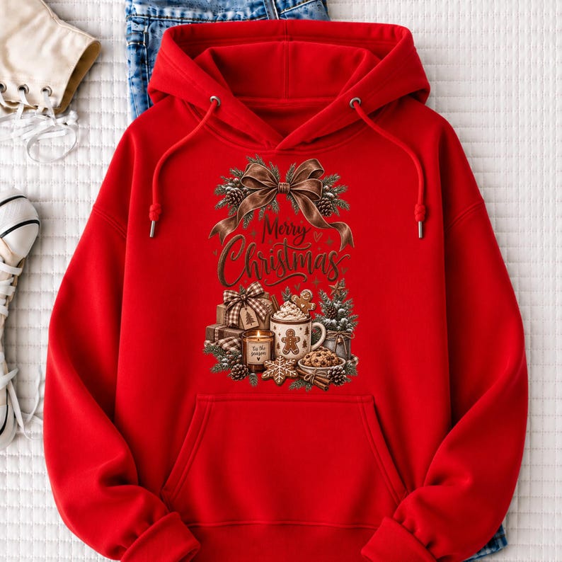A red hoodie with a Christmas-themed design, including a bow, pine cones, and a mug with a Christmas tree, is displayed on a white surface.