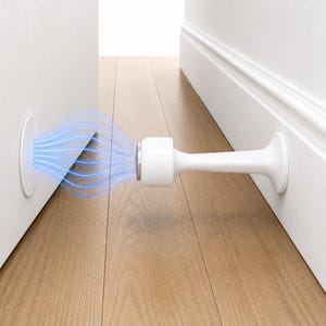 May include: A white magnetic door stop with a cylindrical body and a round base. The door stop is attached to a white door and wall, with blue lines indicating magnetic attraction. The floor is made of wood.
