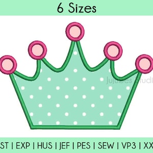 May include: A green crown with white polka dots and pink circles on top. The crown is outlined in green. The text "6 Sizes" is at the top of the image. The text "Jujubes Studio" is at the bottom right of the image. The text "DST | EXP | HUS | JEF | PES | SEW | VP3 | XXX" is at the bottom of the image.