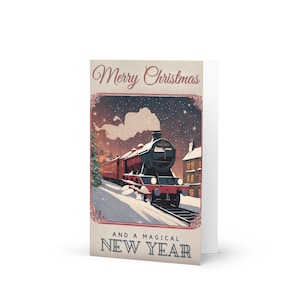 May include: A folded holiday greeting card featuring a vintage illustration of a steam train traveling through a snowy landscape. The card reads "Merry Christmas" and "And a Magical New Year" in a decorative font. The train is red and black.