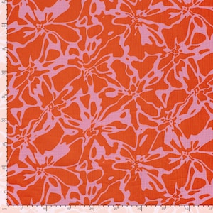 May include: A fabric featuring a repeating abstract floral pattern in vibrant orange and light pink. A metric ruler is visible along the left and bottom edges, indicating a width and height of approximately 45 centimeters for the visible section.