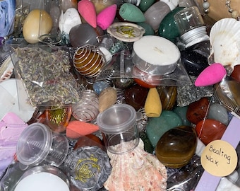 May include: A collection of assorted items including polished gemstones, dried lavender in plastic bags, incense cones, tea light candles, small clear jars, metal wire cages, a seashell, and a stick of sealing wax labelled with the text sealing wax.