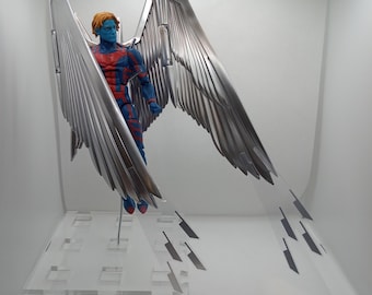 May include: A blue and red action figure with silver wings, standing on a clear plastic display stand.