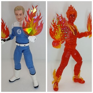 May include: Two action figures: one in a blue and white uniform with a face, and the other in a red uniform. Both figures hold translucent flame-shaped accessories. The blue figure has a white belt and the number 4 on the chest.