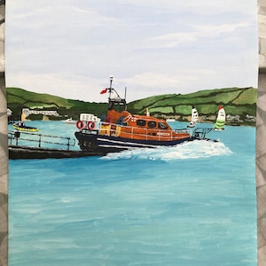 May include: A painting of an orange and blue lifeboat on the water. The boat is leaving a dock and there are two sailboats in the background. The sky is light blue and there are green hills in the distance.
